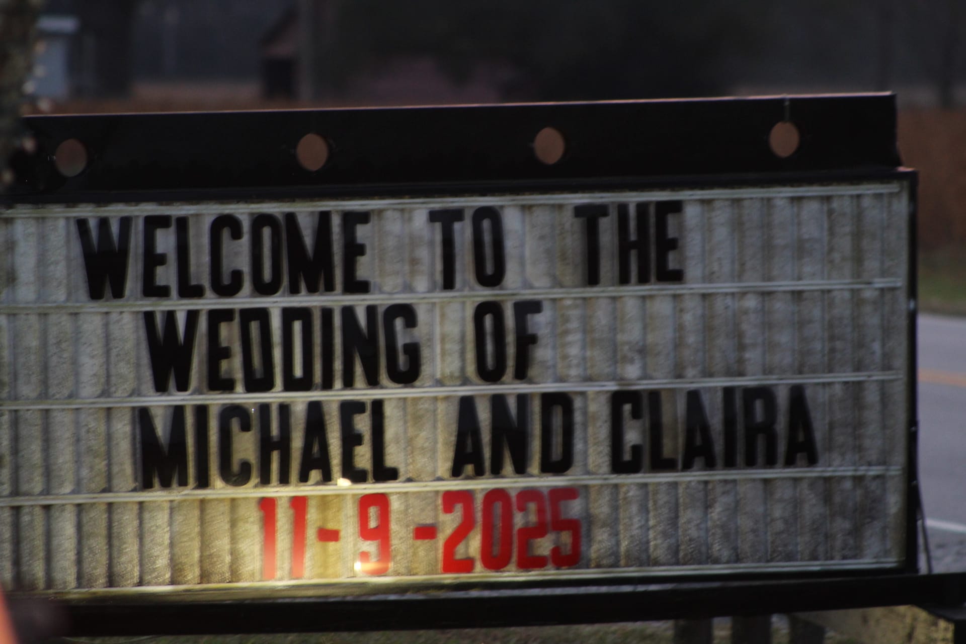 Illuminated marquee sign reading Welcome to the Wedding of Michael and Claira dated 11-9-2025 displayed outdoors at a wedding venue.
