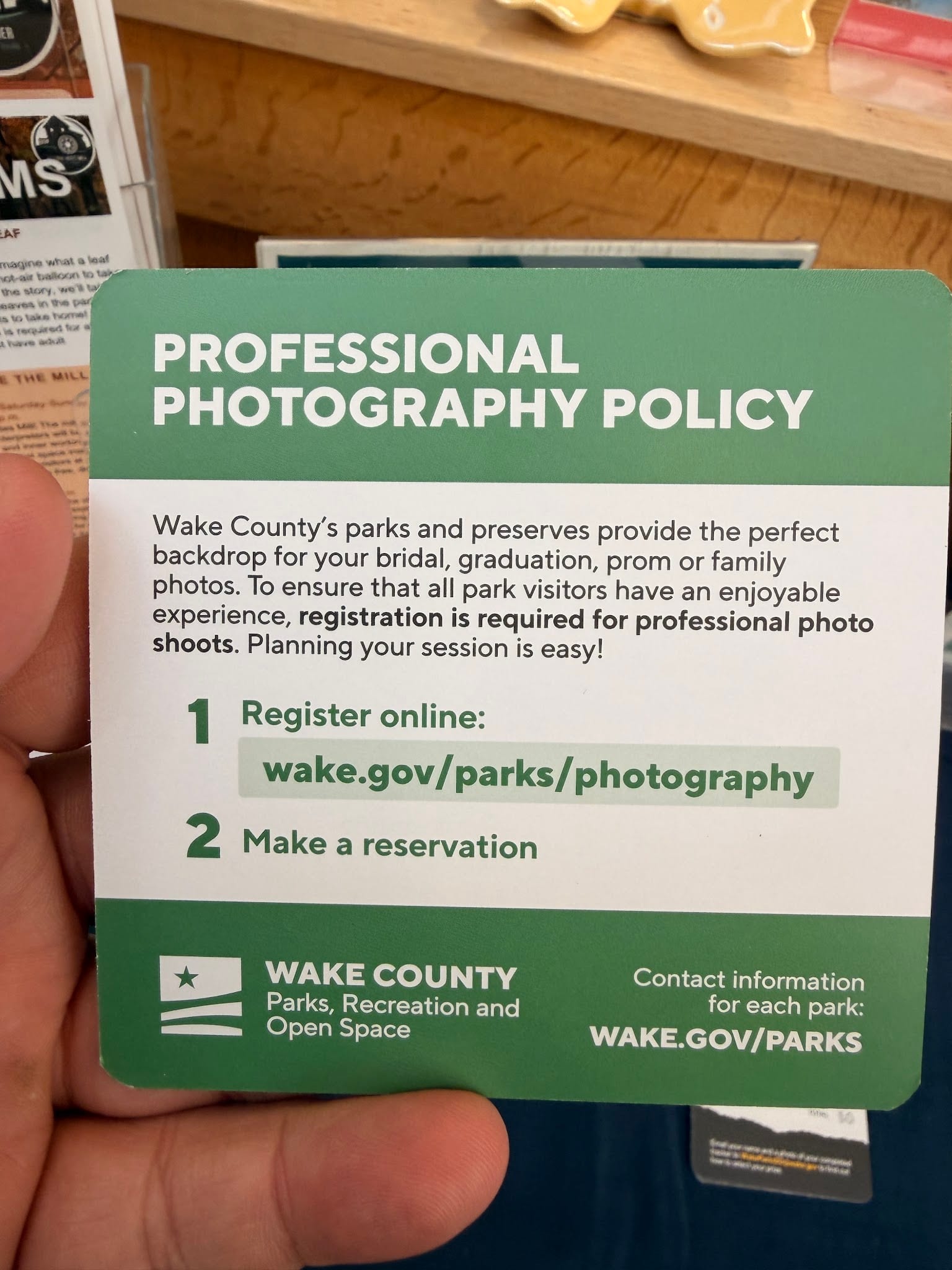 Wake County professional photography policy card photographed at Yates Mill