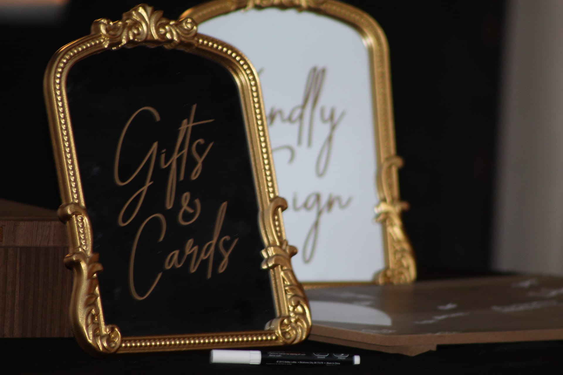 Two ornate gold-framed signs with gold calligraphy reading Gifts and Cards displayed on a table at a wedding reception at Scarborough House.