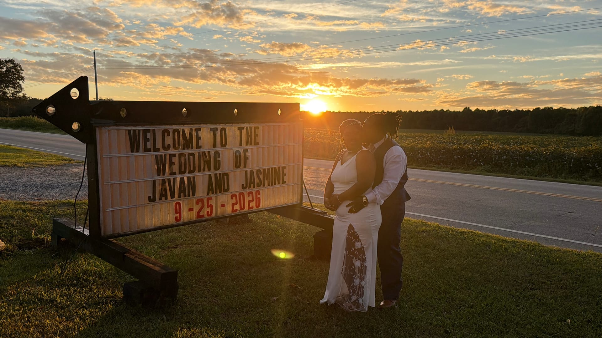 Bride and groom embrace in silhouette beside a glowing welcome marquee sign at sunset during their wedding at Scarborough House on September 25 2026.