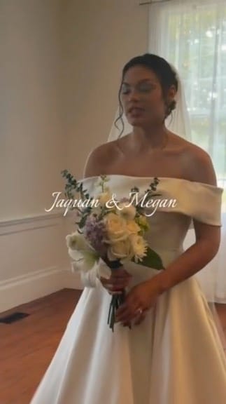 Bride in an off-shoulder white ballgown holding a pastel bouquet of roses and lavender blooms inside the Scarborough House bridal suite.