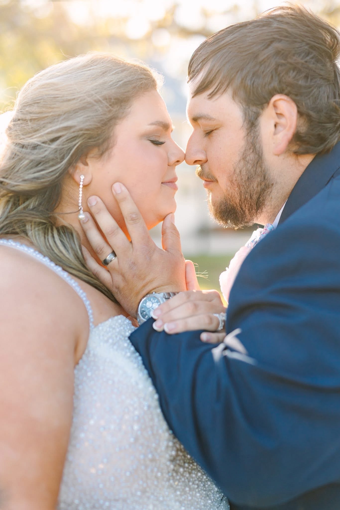 Bride and groom share an intimate almost-kiss bathed in warm golden-hour light at Scarborough House wedding venue.