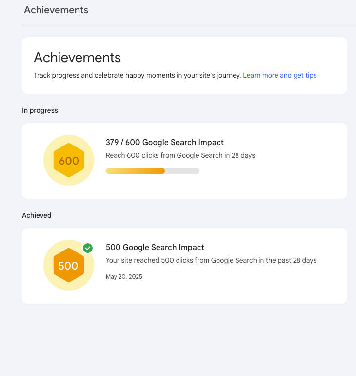 Search Console achievements showing 379 of a 600-click goal and a separate 500-click achievement dated May 20, 2025