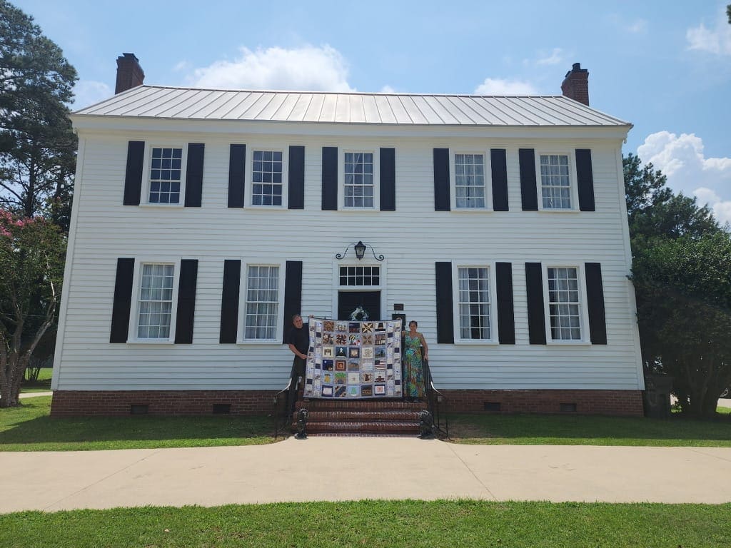 The America's 250th anniversary quilt held on the front steps of Scarborough House, the oldest home in Wilson County, Stantonsburg NC