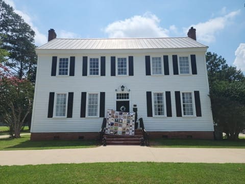 The 250th anniversary quilt draped over the front steps of the Federal style Scarborough House in Stantonsburg, NC