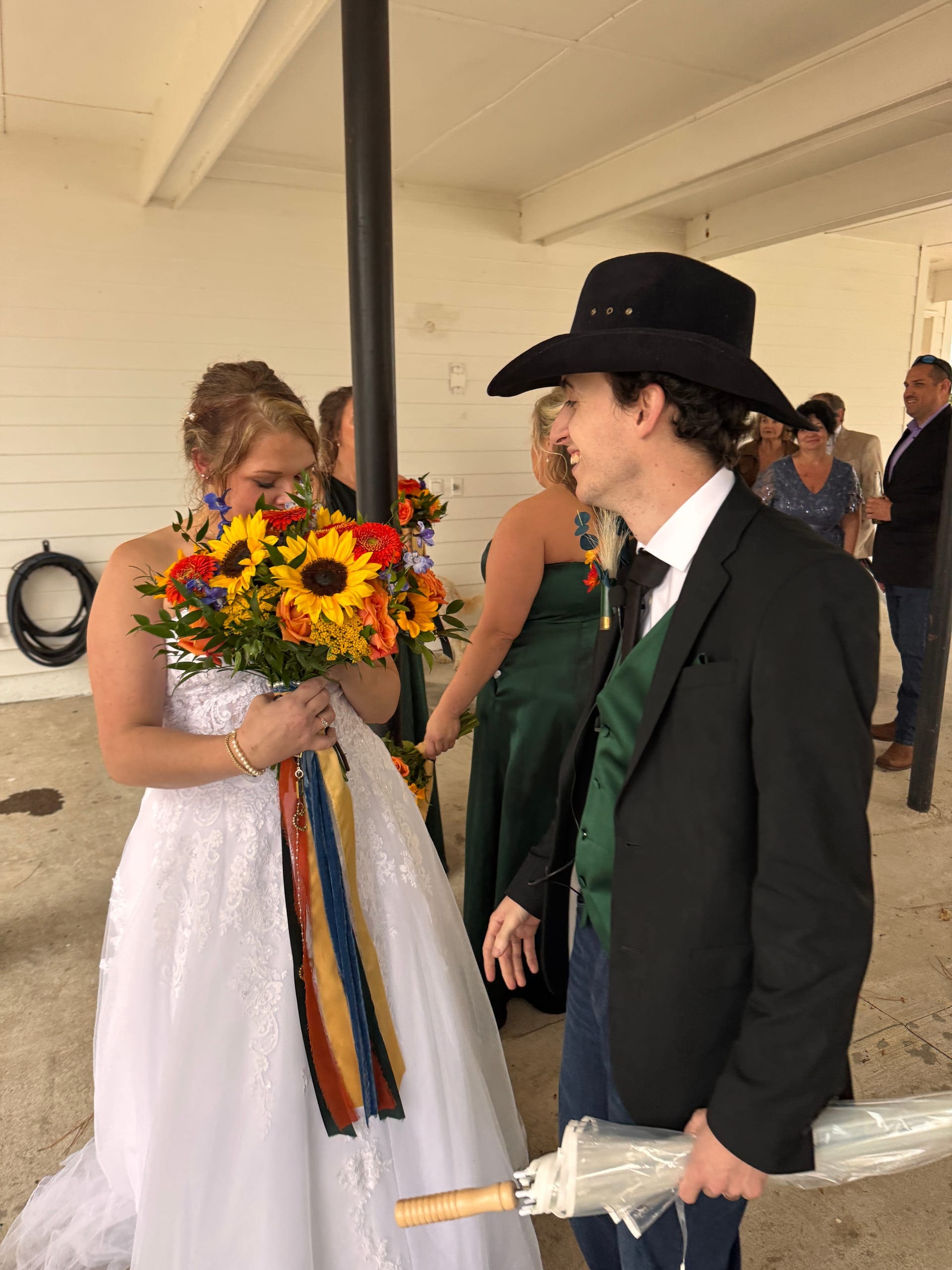 Couple with sunflowers at golden hour at Scarborough House