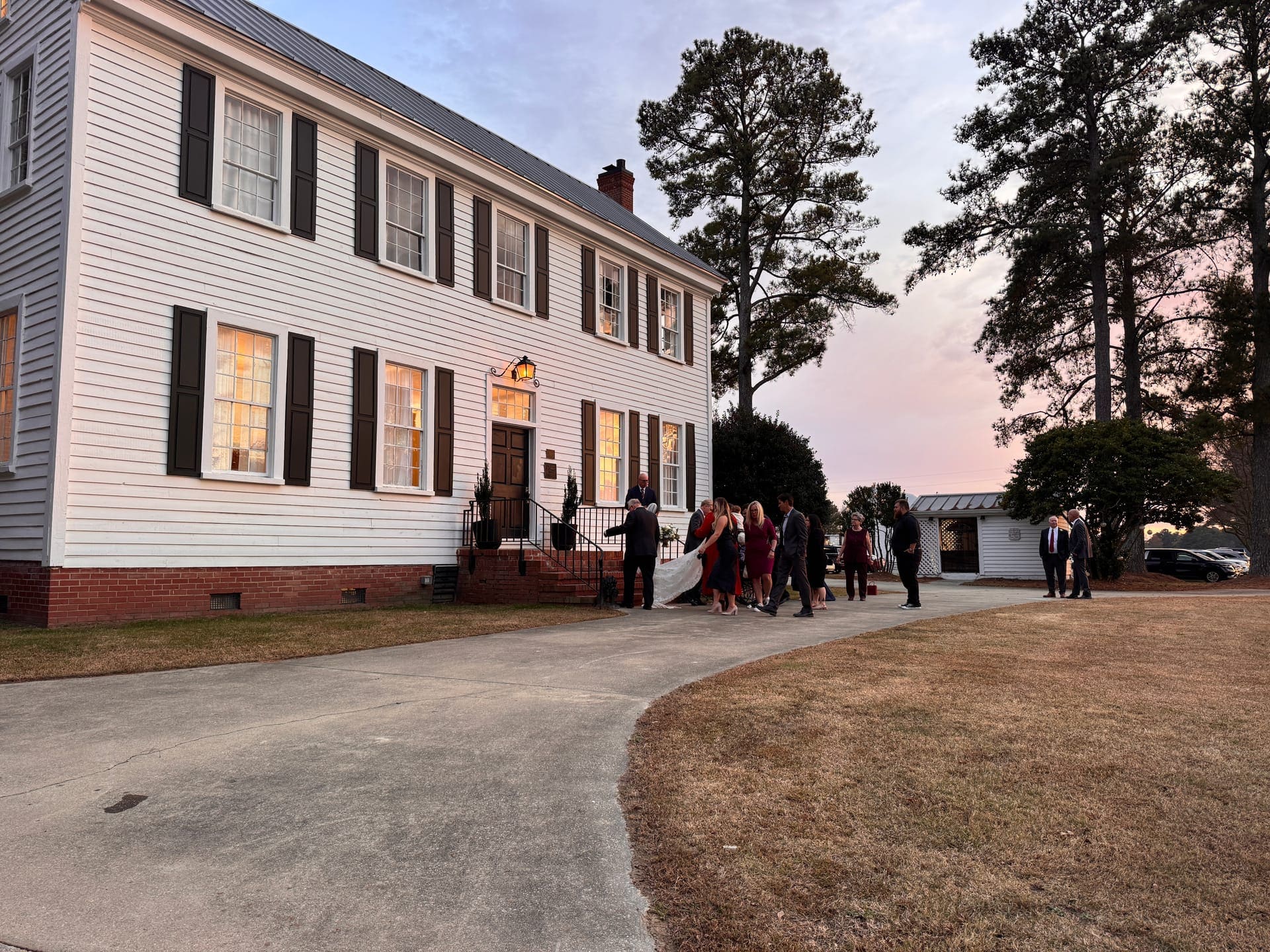 Fall wedding at Scarborough House with the historic white Federal-style home behind autumn trees in Stantonsburg NC